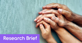 Image of a family of hands of different again wrapped around each other. Wording on the banner reads, "Research Brief"