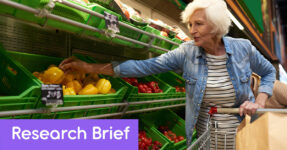 Older woman with gray selecting a yellow pepper in a grocery store. Text reads, "Research Brief"