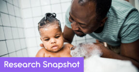 African American father giving his child a bath