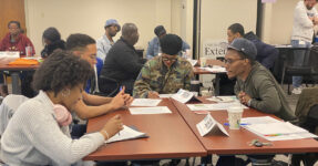 young people talking sitting around a table