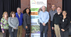 group of eight adults smiling