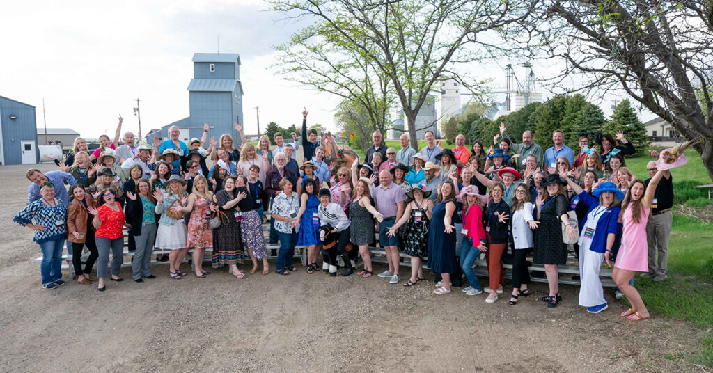 Group of excited people standing in a parking lot.