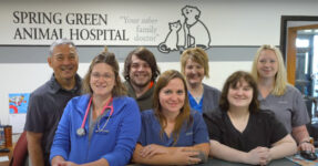 A group of people standing behind a counter.