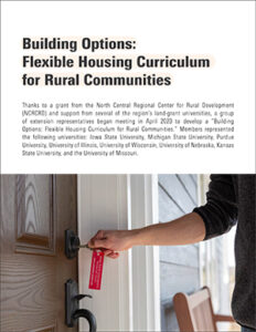 man's hand holds a key and is unlocking a door to a new home