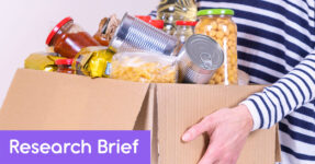 woman holding a box of food from a food pantry